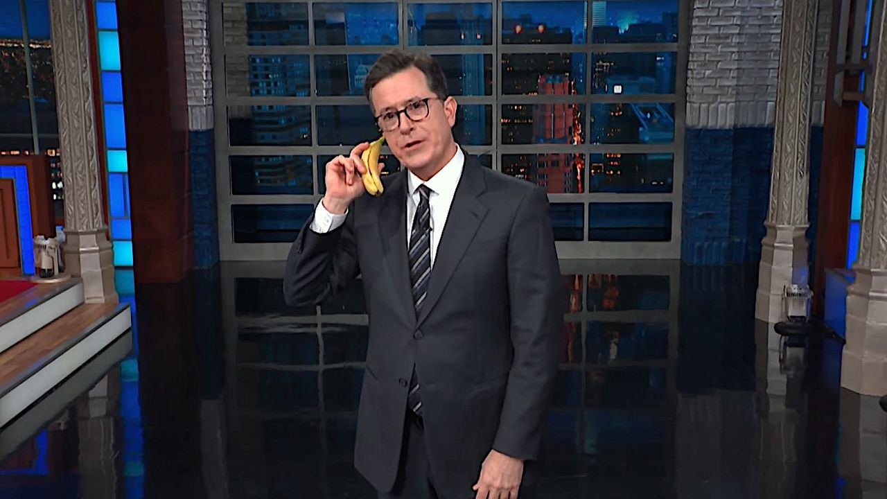 Stephen Colbert talks on a banana