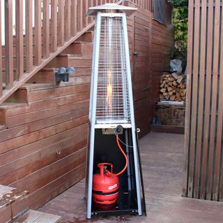 The Outsunny 11.2kw Pyramid Gas Patio Heater with a red gas tank fitted