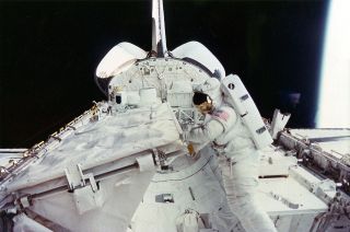 Kathryn Sullivan is seen conducting the first spacewalk by a U.S. woman outside space shuttle Challenger in October 1984.