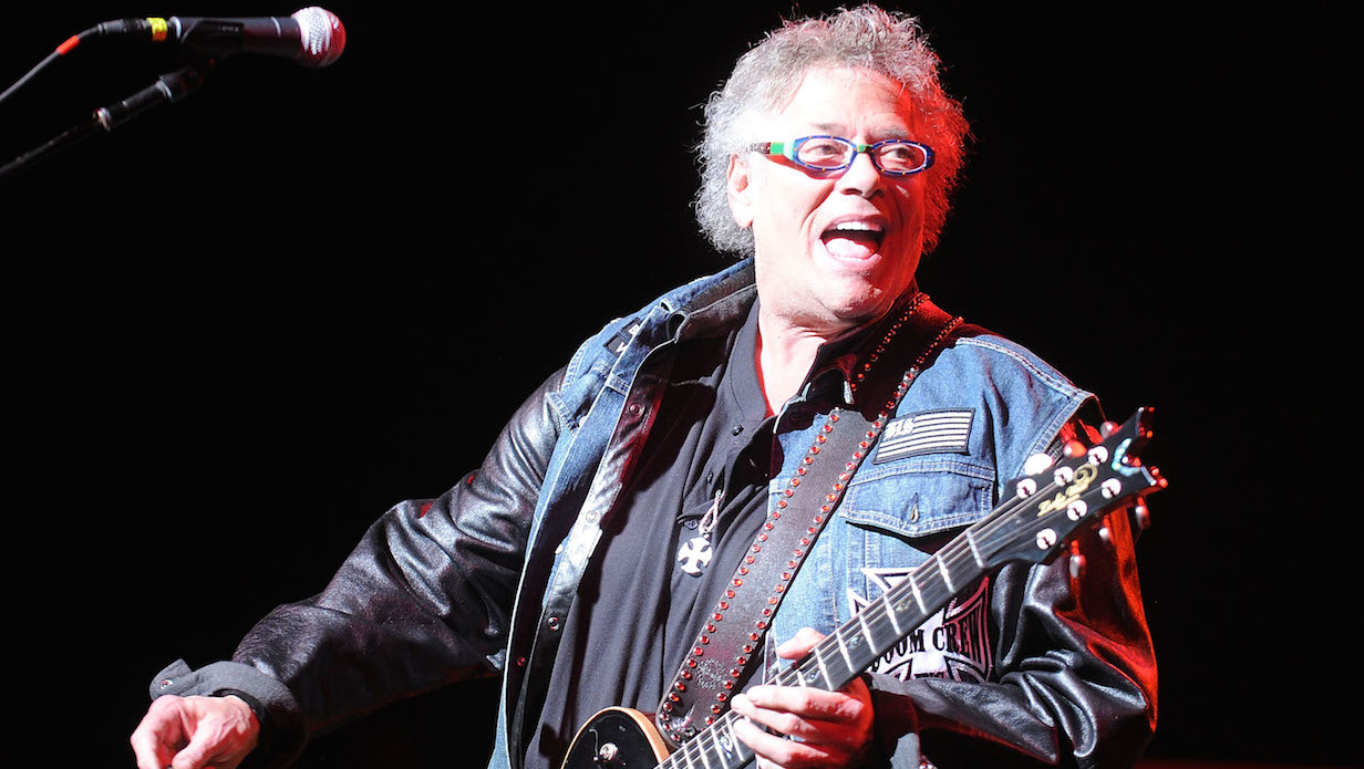 Leslie West onstage holding a guitar