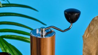 the comandante c40 mk4 hand coffee grinder with a glass catch chamber and high nitrogen steel burrs