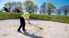 Raking bunker before playing shot