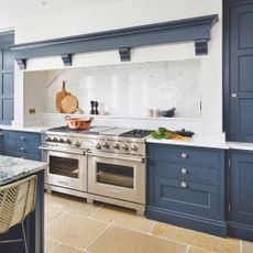 stainless steel range cooker in blue kitchen