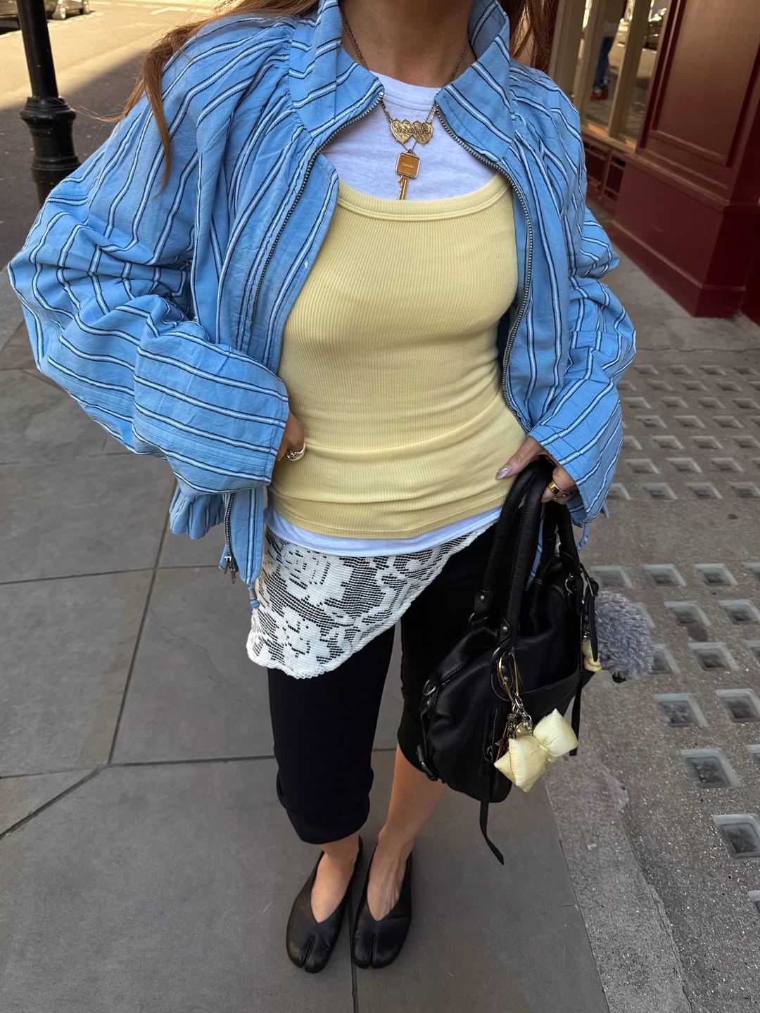 Influencer Rebecca Ferraz Wyatt wearing layered vests.