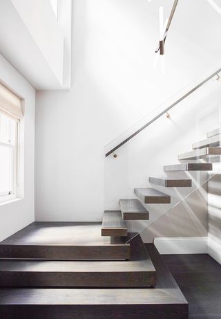 large concrete stair case with glass panels