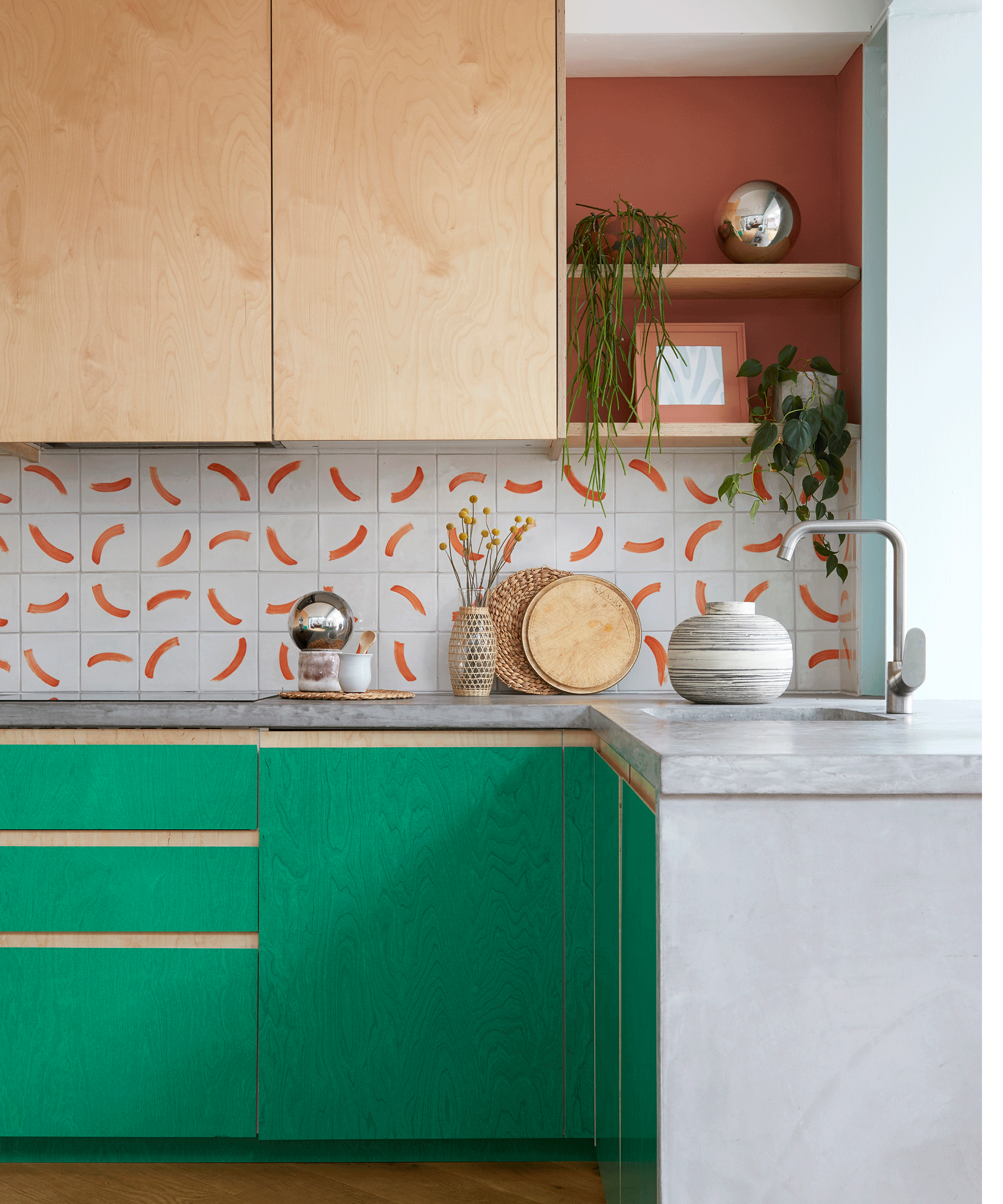 two tone kitchen with green and wood cabinetry and patterned splashback