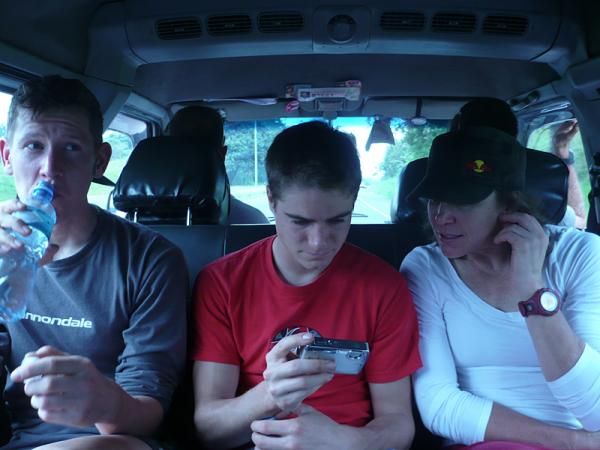 Race leader Ben Sonntag, Blake Harlan and Rebecca Rusch share post-stage stories while catching the shuttle to their race hotel.