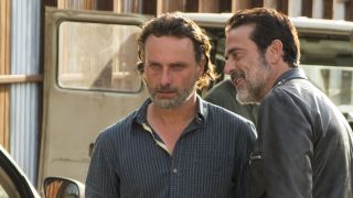 Negan grinning in Rick's angry face as he walks away in The Walking Dead