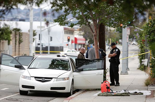 Police officers investigate the car belonging to James Howell.