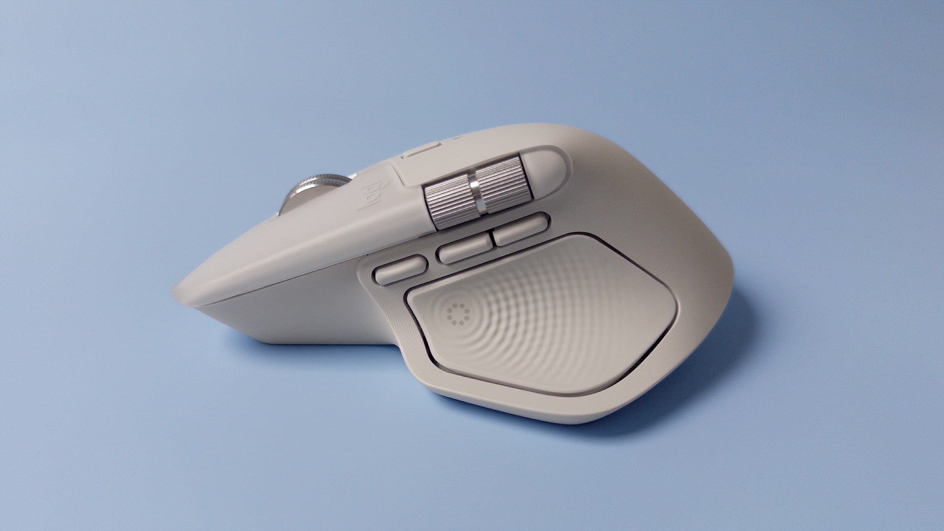 The Logitech MX Master 4 mouse against a blue background.