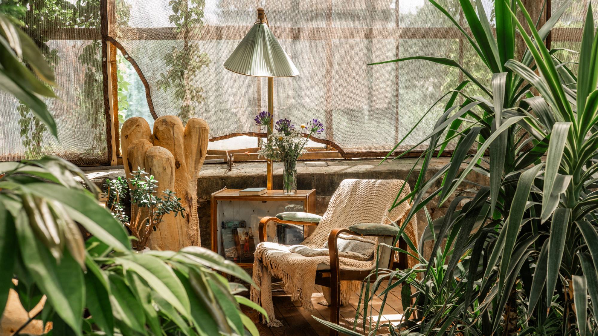 A charming reading nook in a greenhouse