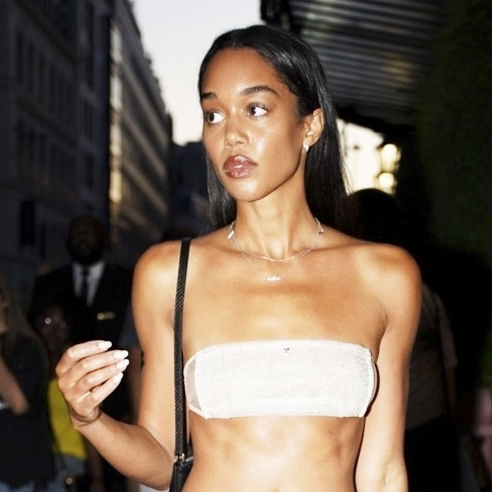 Laura Harrier wearing a white bandeau and skirt in Paris 