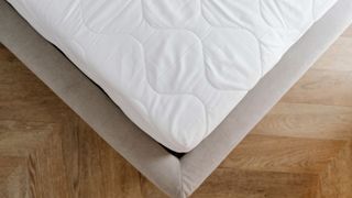 corner of a mattress with mattress protector on