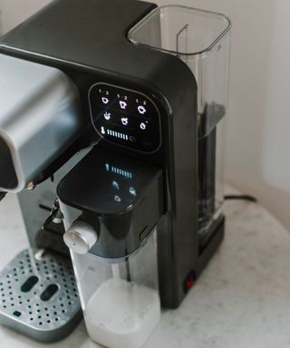 A close up of water tank and touch screen on Mr. Coffee Prima Latte Luxe