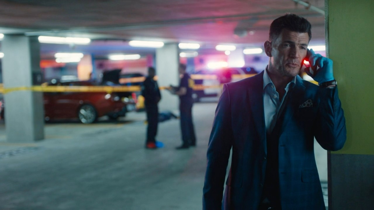 Aiden Turner on the phone in High Potential