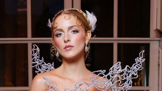 McKenna Grace looks regal in a white feathered vintage dress that was modified to look like Jennifer Lawrence's in Catching Fire.