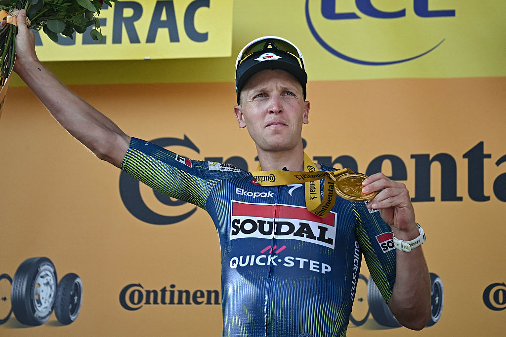 Soudal Quick-Step team's Belgian rider Tim Merlier celebrates on the podium after winning the 8th stage of the 113th edition of the Tour de France cycling race, 182 km between P&amp;eacute;rigueux and Bergerac in southwestern France, on July 11, 2026. (Photo by Loic VENANCE / AFP)