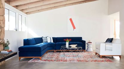 Best sleeper sofas. APT2B blue sleeper corner sofa in large living room, wooden ceiling, carpet on floor