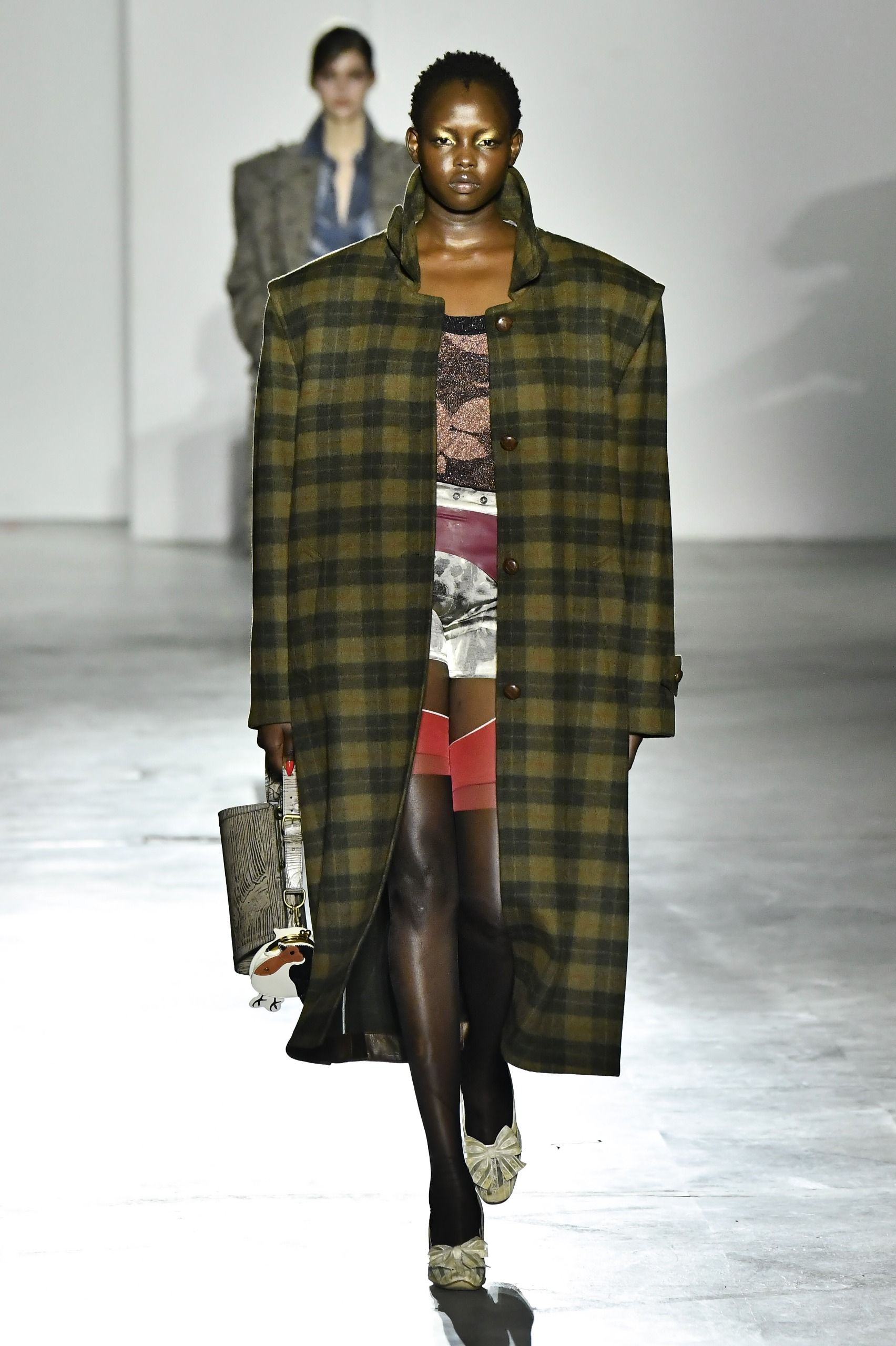 A model wore a flannel coat on Vivienne Westwood's Fall 2026 runway