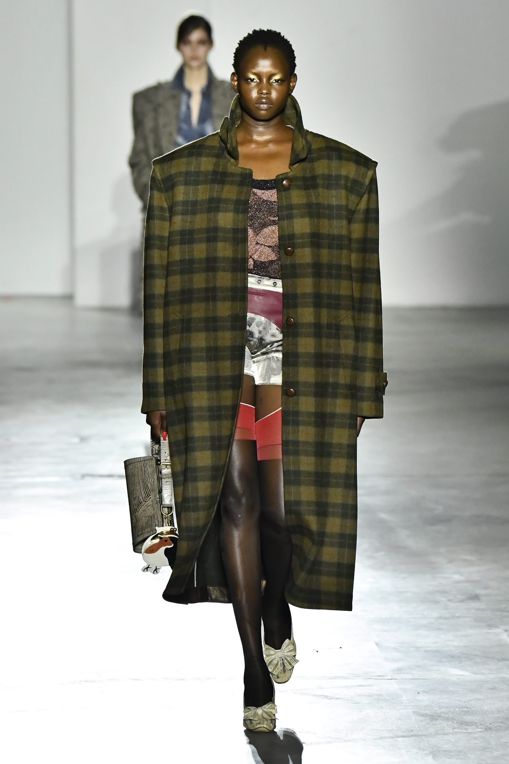 A model wore a flannel coat on Vivienne Westwood's Fall 2026 runway