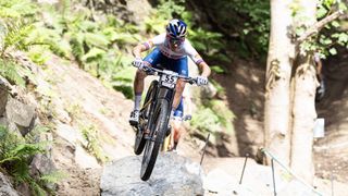 Tom Pidcock on the feature jump at Glentress