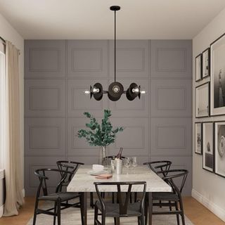 A sculptural black light fixture hanging above a dining table