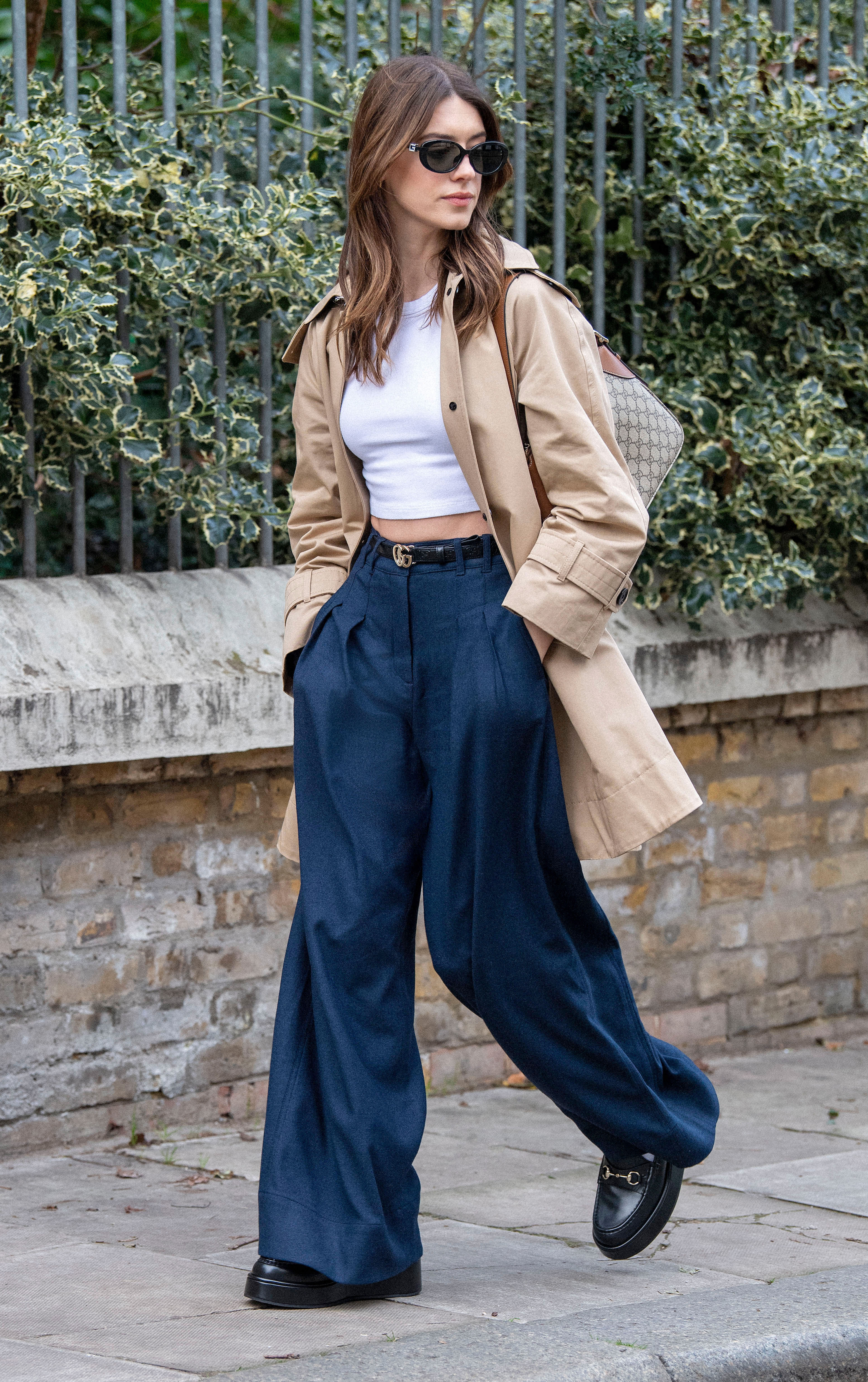 Daisy Edgar-Jones wearing a trench coat and jeans in January 2025