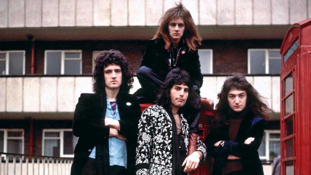 Queen posing outside a block of flats circa 1973