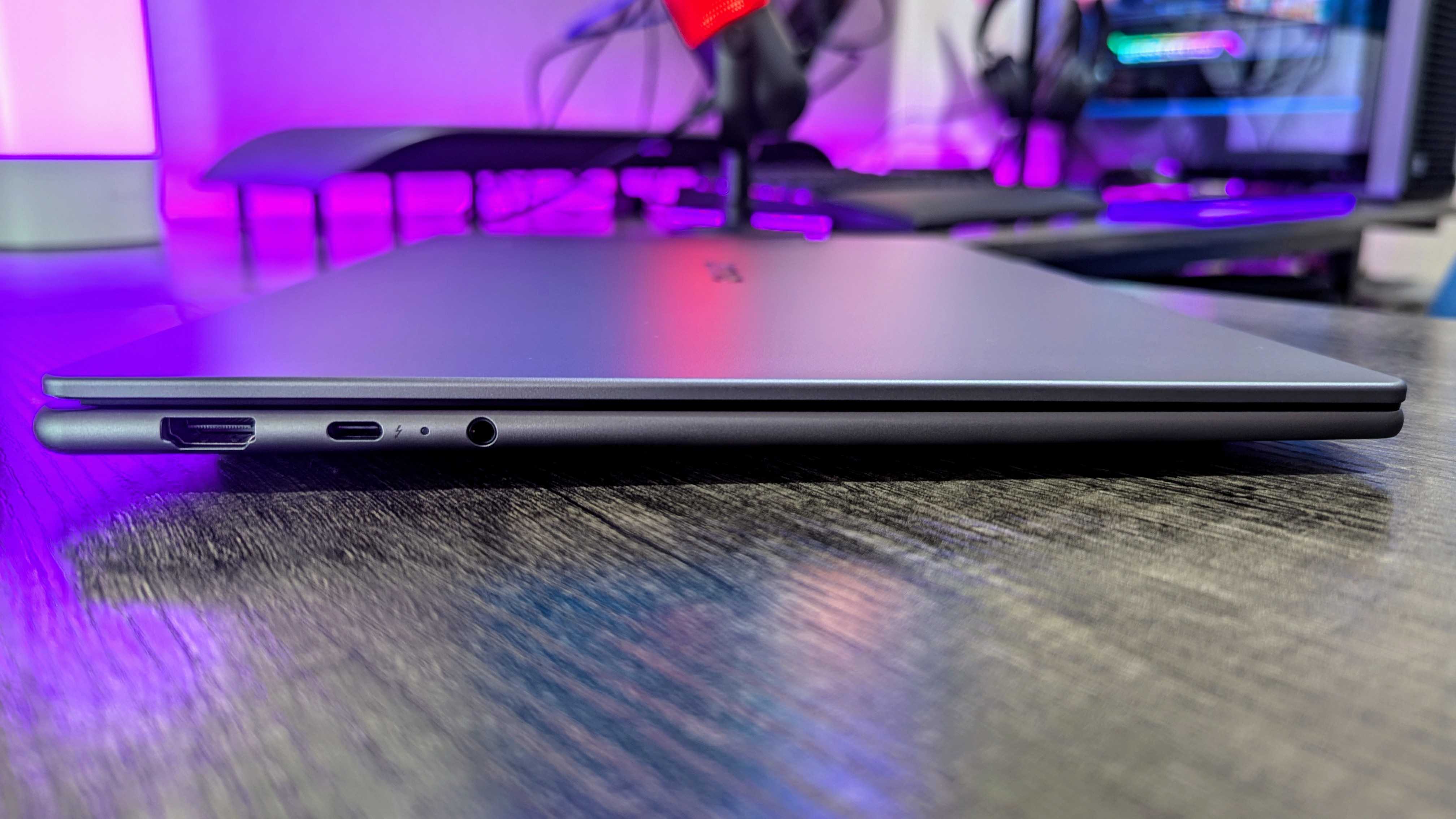 The Lenovo Yoga Slim 7i (Gen 9) Aura Edition from the side, showing the HDMI, Thunderbolt 4, and 3.5mm audio ports.