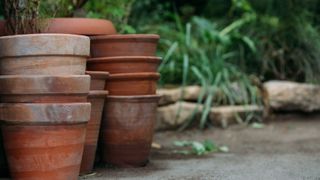 picture of terracotta pots stacked in garden