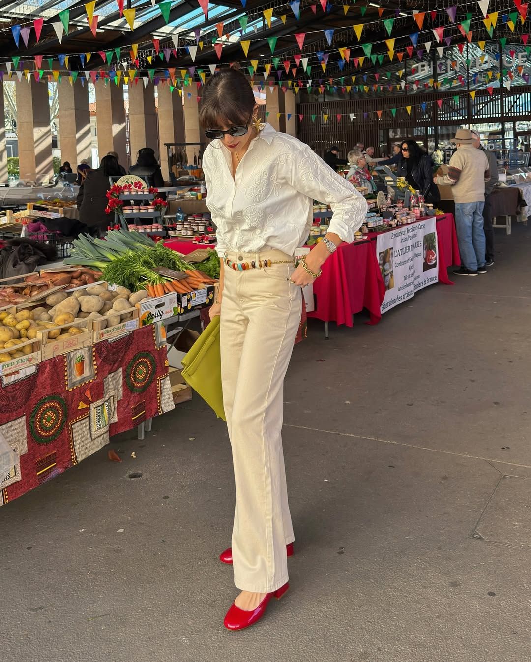 Woman in jeans, shirt, and red shoes