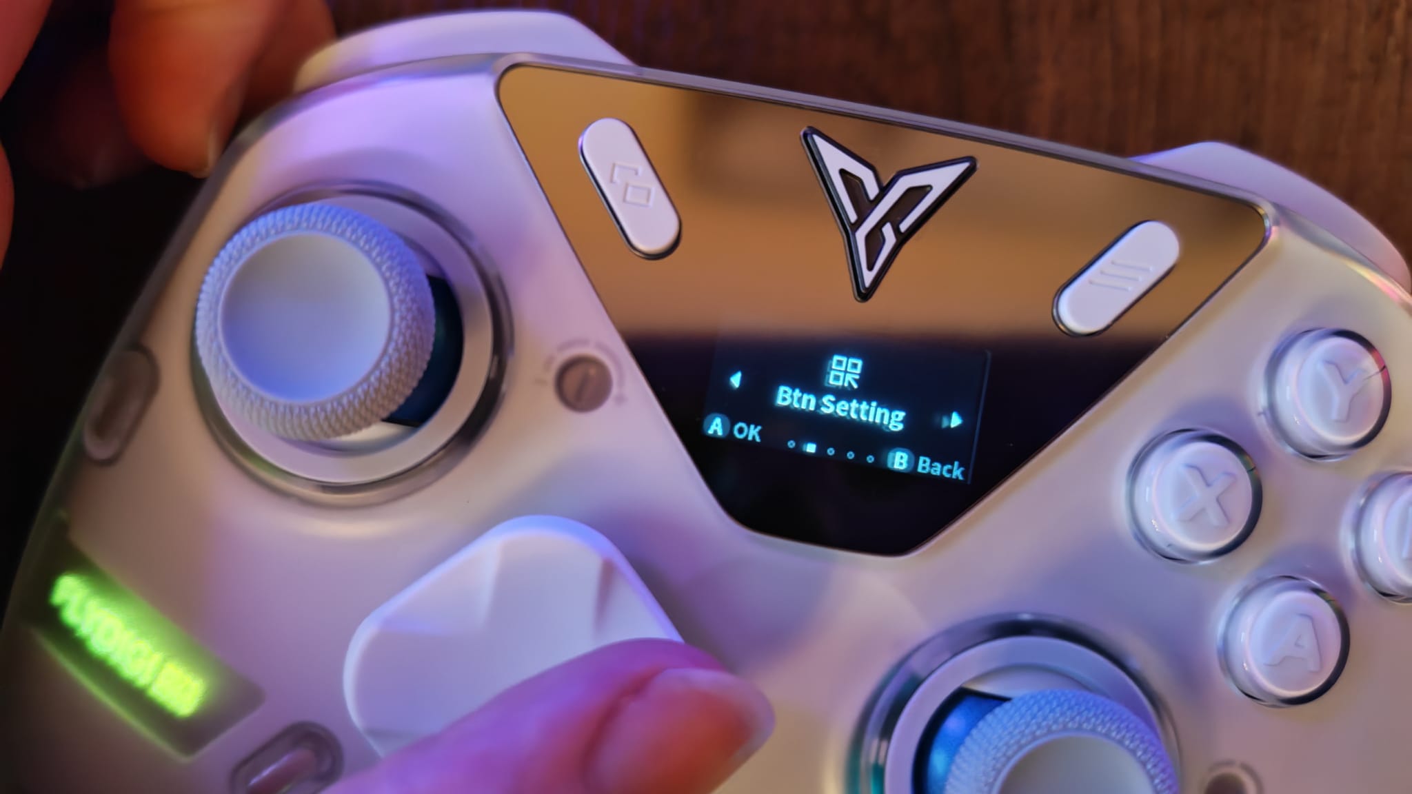 A reviewer navigating the button settings menu on the Flydigi Apex 5