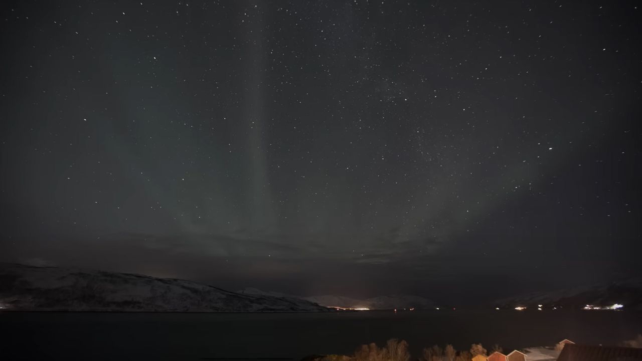 The Northern Lights taken with a short exposure, more similar to the human eye. The lights are barely visible and appear dull.