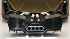 iXOOST ESAVOX speaker in front of a same-coloured Lamborghini supercar