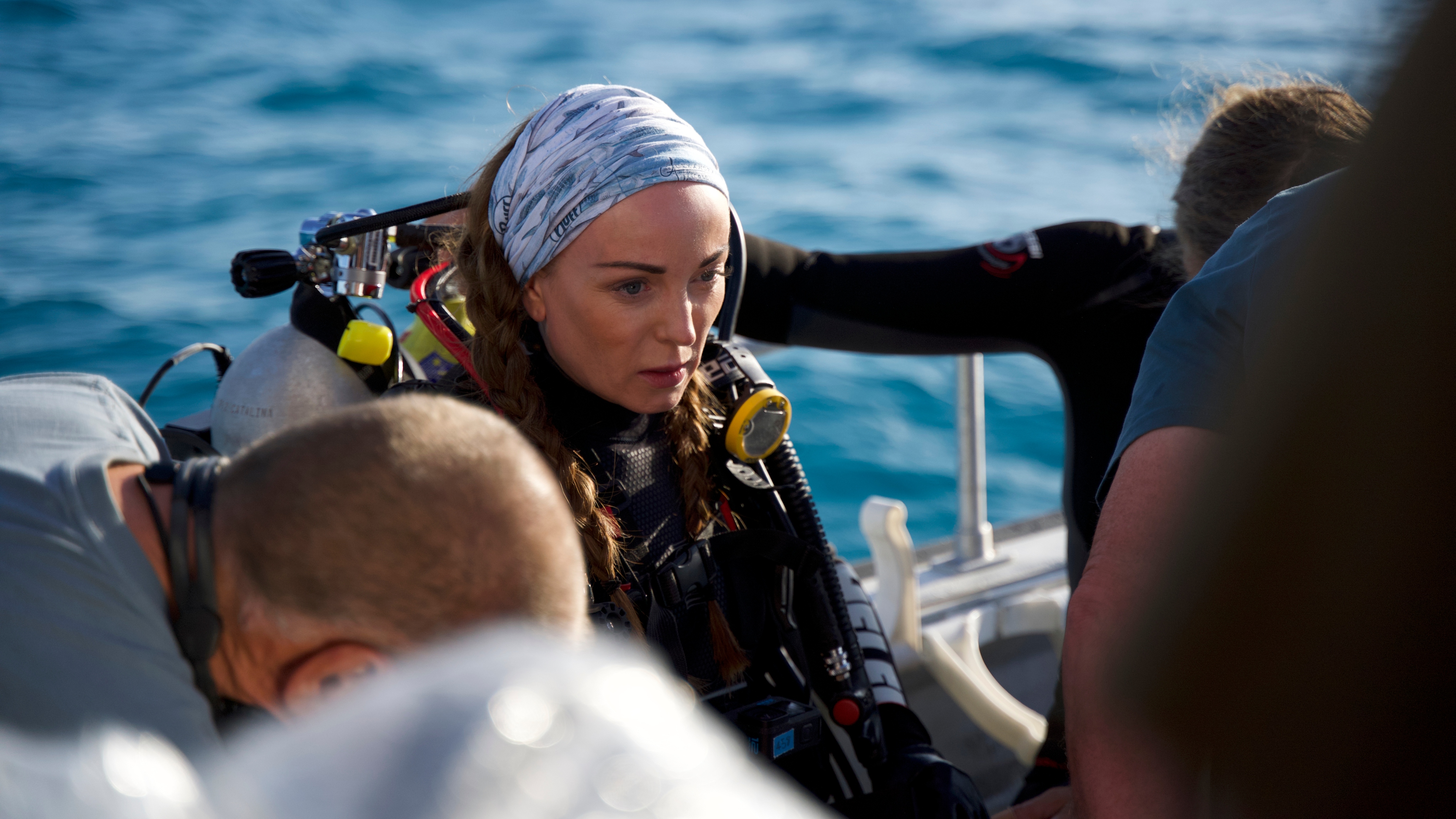 Helen George looking nervous on a boat as she wears diving gear