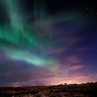 northern lights shine over iceland