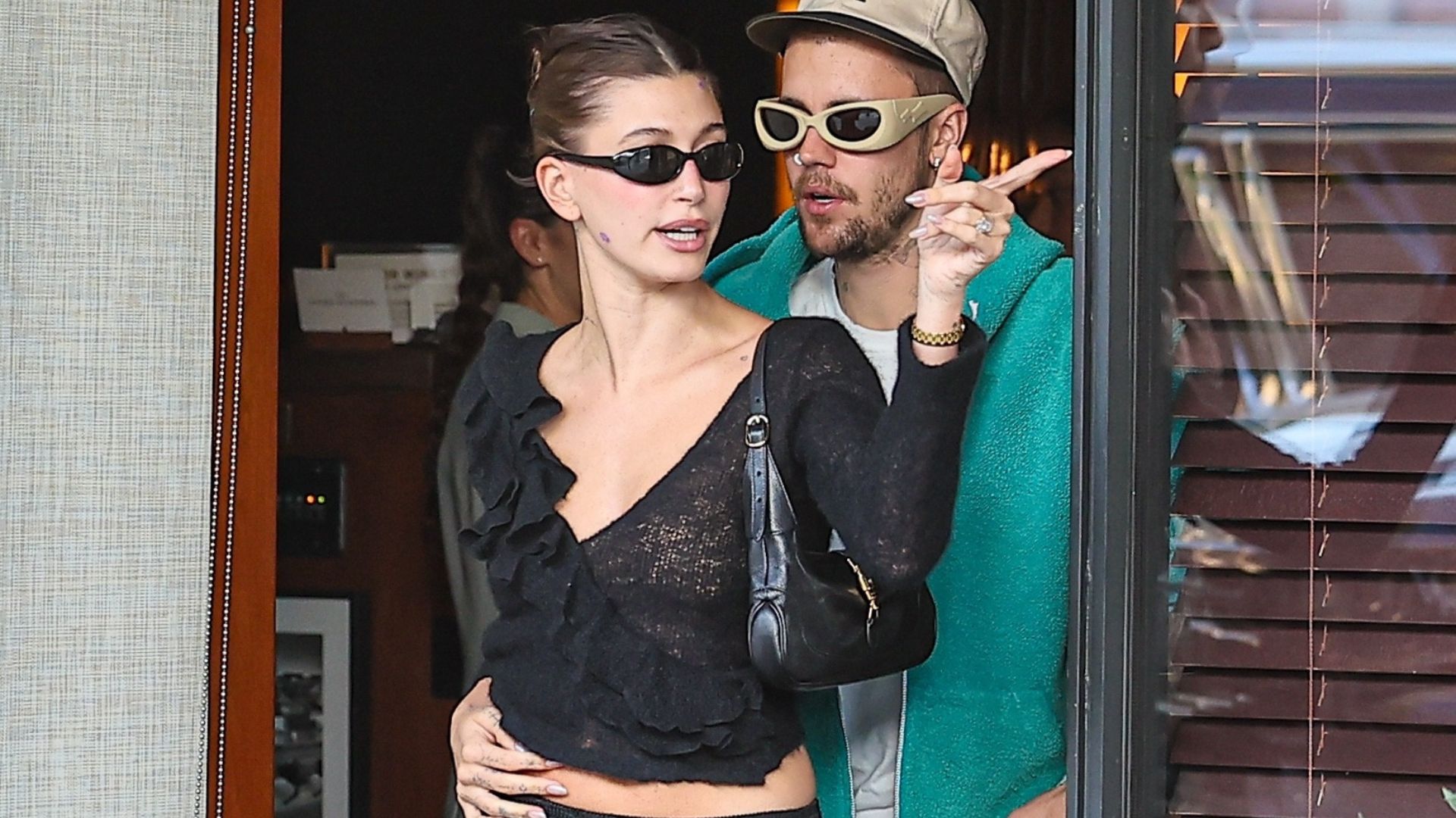 Hailey Bieber in Beverly Hills wears a black crochet knit top and carries Gucci Jackie Slim Bag