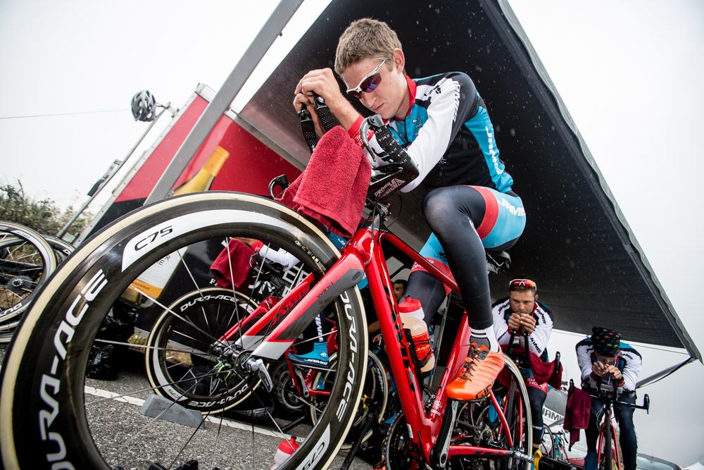 Kyle Murphy (Jamis) tries to stay dry while warming up before todays stage
