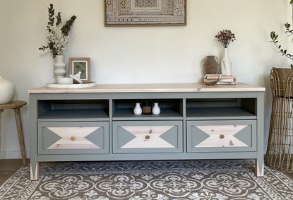 A customised IKEA HEMNES TV unit painted pale green with a geometric pattern 