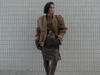 a woman in a leather bomber jacket