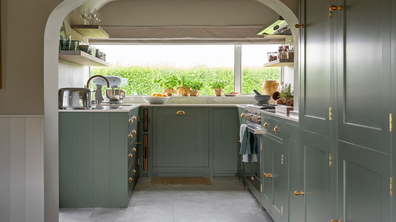 small green kitchen with roman blinds