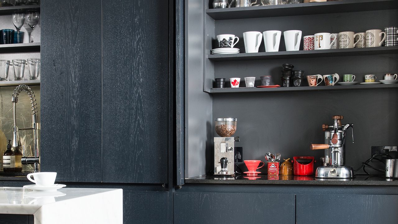 Dark grey kitchen with coffee station that can be hidden behind pocket doors