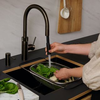 Tap with spray being pulled out to wash veg