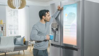 A man checking his smart fridge