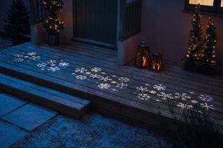 snowflake images projected onto a doorstep