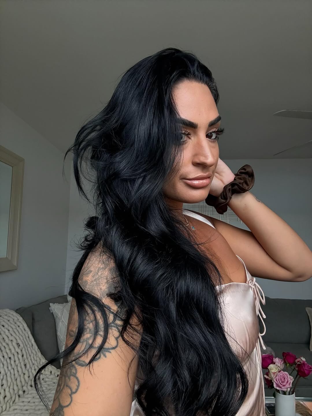 a selfie of a white woman with long, black hair