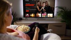 Female watching TV series and movies via streaming service at home