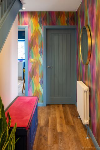 A narrow entryway painted in pop colors and a storage unit in bright tones