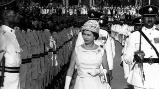 Queen Elizabeth II inspects a guard of honour in Trinidad during a royal tour of the Caribbean.