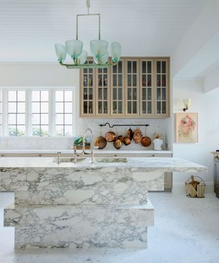 Tiered marble kitchen island in white kitchen